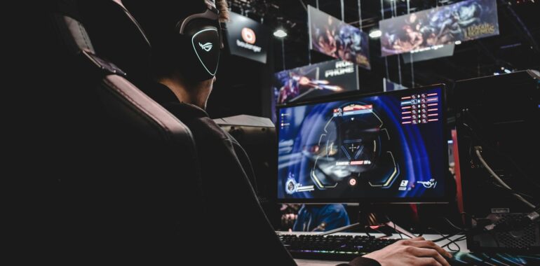 person sitting on gaming chair while playing video game